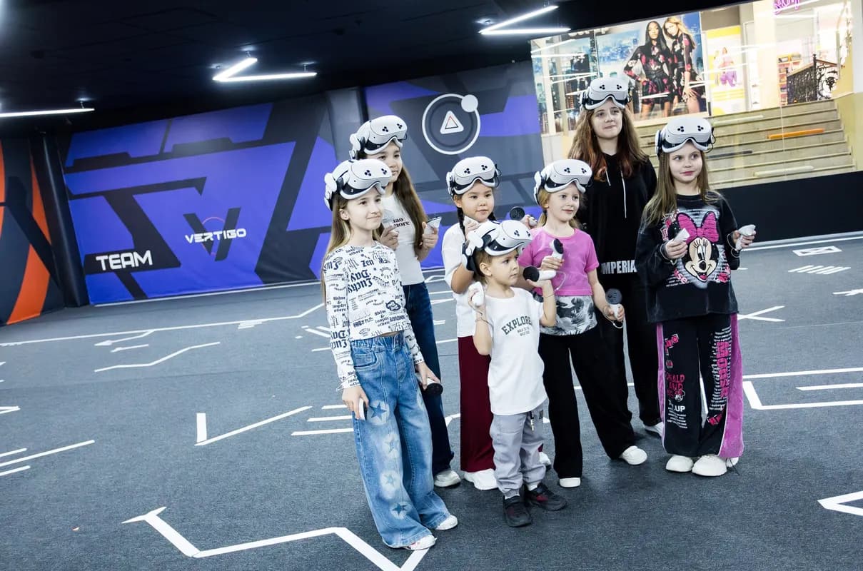 Группа детей в VR-шлемах на игровой арене